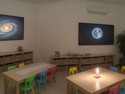 Professor demonstrando estratégias de ensino da matemática com recursos didáticos e alunos engajados em sala de aula.