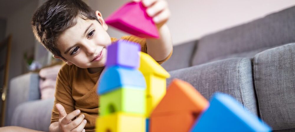 Funny boy playing with blocks at home Funny boy playing with blocks at home