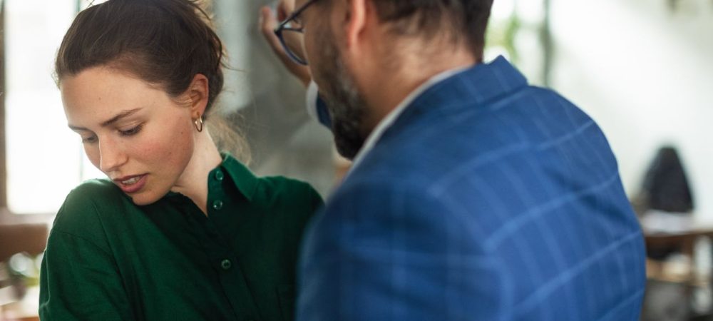 O que é assédio moral? Homem, supostamente um chefe, humilhando uma funcionária